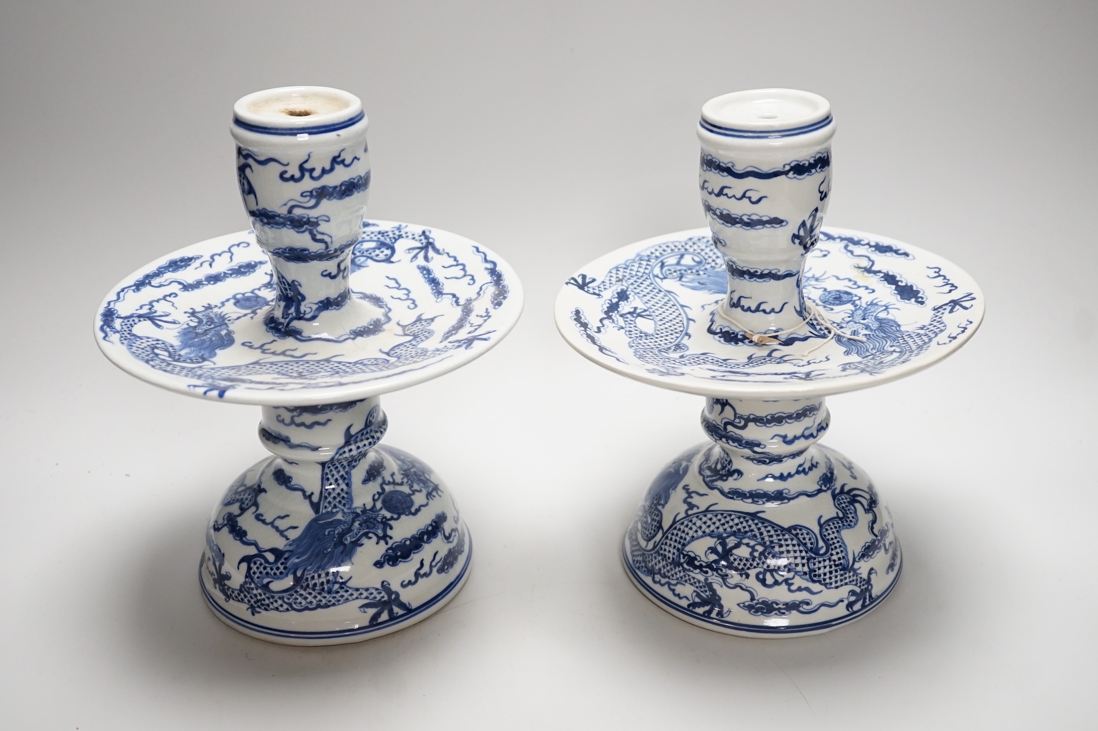 Two Chinese blue and white candlesticks and a turquoise glaze dragon vase, 30cms high